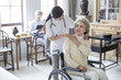 © Blue Jean Images - Nurse talking to senior female patient in wheel chair