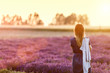 © Photocreo Bednarek - Young woman relaxing looking on lavender field at sunset