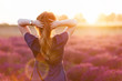 © Photocreo Bednarek - Young woman touching her long sombre hair looking at lavender field at sunset