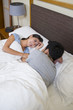 © Blue Jean Images - Young couple lying on bed