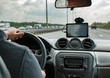 © makcoud - man driving car with hands on the steering wheel and using the GPS navigation