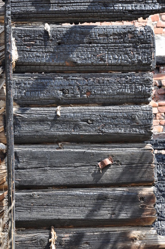 Close Up View Of Charry Log Ends Of A Burnt Wooden House Against A