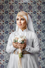Wall Mural - Woman Oriental Bride during nikah ceremony in muslim fashion dress and hijab scarf at the mosque