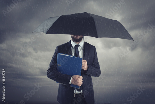 Businessman Below Storm With Umbrella Businessman Below Storm With Umbrella