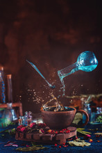 Flying Potion Bottle With Pouring Liquid In A Magical Still Life. Brewing Magical Tea.