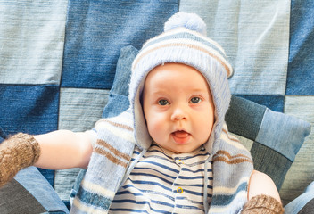 Wall Mural - portret funny baby boy in a warm hat