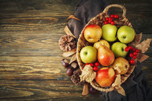 Basket With Fresh Apples And Pears On A Wooden Table. Autumn Background.