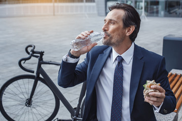 Senior business man with a bicycle outdoors