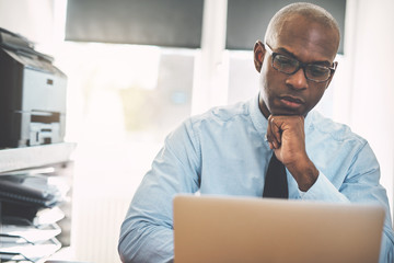 African businessman hard at work online in an office