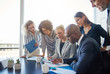 © Flamingo Images - Focused group of office colleagues reading paperwork in a boardroom