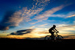 Silhouette of cyclist in motion on the background of beautiful sunset,ride bicycle on sunset background,Silhouette of man ride a bike in sunset background.