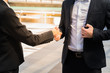 © shutterdemon - Two confident business man shaking hands for demonstrating their agreement to sign agreement or contract between their firms / companies / enterprises. success, dealing, greeting and partner concept.