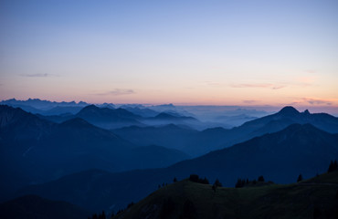 Evening blue Mountain Panorama with fog, sunset orange moody