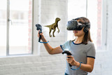 Fototapeta Sypialnia - A teenage student wearing a virtual reality headset to study science.