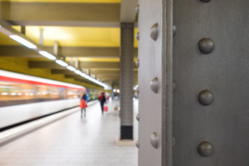 Wall Mural - Underground station with arriving Train and blurred background