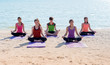 © weedezign - Yoga class at sea beach in sunny day ,Group of people doing lotus pose with clam relax emotion,Meditation pose,Wellness and Healthy balance lifestyle