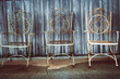 vintage iron chairs in front of weathered building