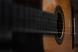 Acoustic guitar background, unusual view. Blurred photography, selective focus. Copyspace, perfect as wallpaper or backdrop for design, poster, flyer or prints.
