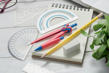 School stationery and office supplies on white table, math concept.