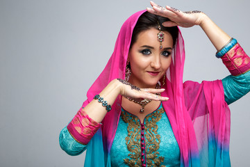 Portrait of beautiful smiling indian girl. Young indian woman model with traditional jewelry set . Indian costume saree