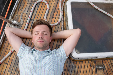 Wall Mural - Man on deck. Resting on yacht duting vacation.