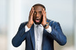 © DenisProduction.com - Shocked afro american businessman. Black man hold hands on head and open mouth with astonishment. Black man in full disbelief.