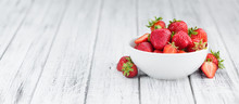 Portion Of Strawberries On Wooden Background, Selective Focus