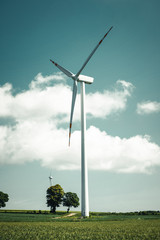 Windmill power generation over sunny landscape.