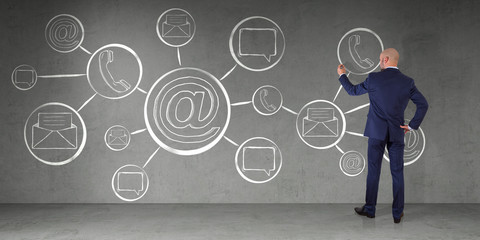 Wall Mural - Businessman drawing contact and internet sketch on a wall 3D rendering