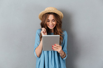 Canvas Print - Beautiful young caucasian woman chatting by tablet