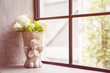 Flower pot, there is a white rose, Cupids, placed by the window. Vintage home decoration