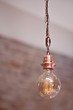 An ancient lamp hanging on the ceiling, a brick backdrop, all the positive thinking ideas, home furnishings, vintage paintings.