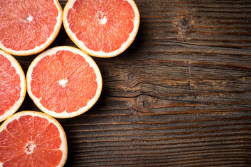 Sticker - Red grapefruits on an old wooden table