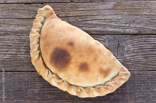 Fotografía Cornish pasty on wooden background