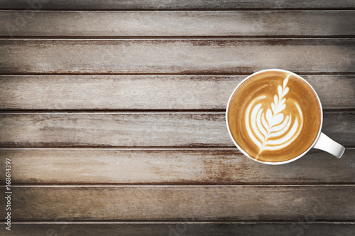 Cup of hot latte coffee us on top of wood table Tableau sur Toile