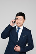 © LIGHTFIELD STUDIOS - Half-length shot of smiling businessman in a suit talking on the phone
