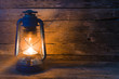 A kerosene lamp on the old wooden background