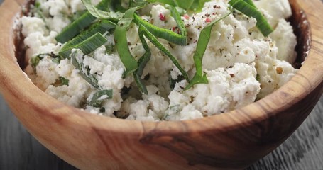 Wall Mural - fresh ricotta with herbs in olive wood bowl on old table