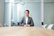 © pressmaster - Serious applicant sitting by desk in boardroom and waiting for employer questions