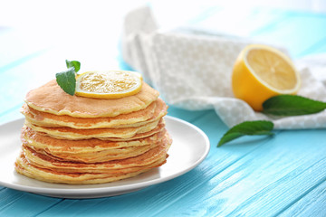 Wall Mural - Plate with delicious pancakes and lemon on table