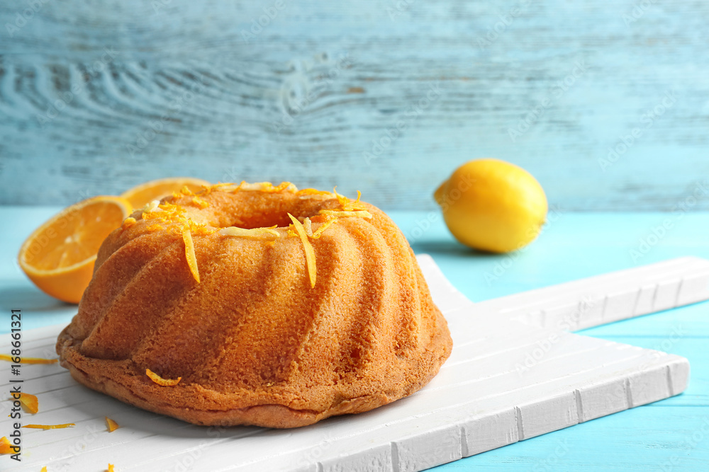 Delicious citrus cake with orange zest on table