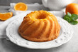© Africa Studio - Plate with delicious citrus cake and orange zest on light table