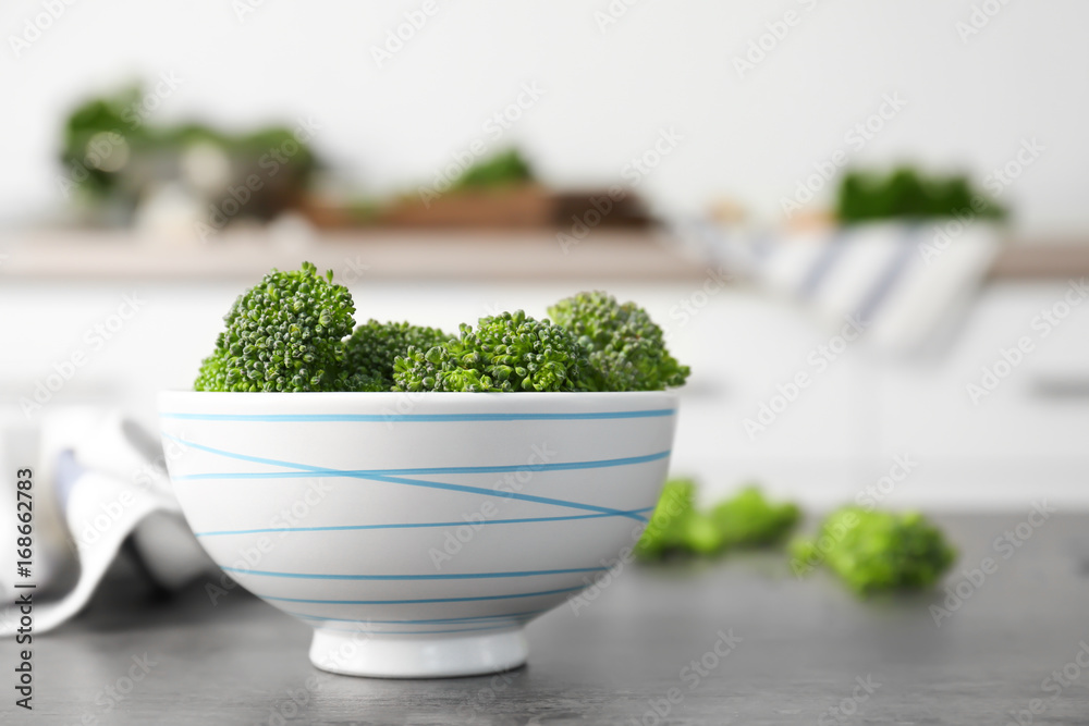 Fresh green broccoli sprouts in bowl on kitchen table