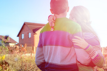 Wall Mural - Rear view of young couple looking at their new house