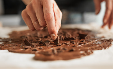 Professional confectioner making tasty cake with melted chocolate