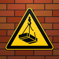 International safety warning sign. Beware of falling loads The sign on the brick wall background. Black image on a yellow triangle. Vector illustration.