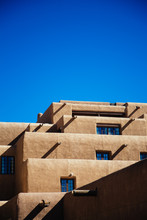 Adobe Style Building In Santa Fe, New Mexico Against A Clear Blue Sky