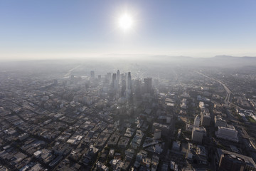 Wall Mural - Smoggy afternoon aerial view of urban downtown buildings, streets and towers in Los Angeles, California. 