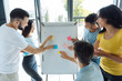 © zinkevych - Joyful delighted people standing around the whiteboard