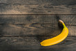 Ripe yellow banana on the old rough scratched wooden board background surface